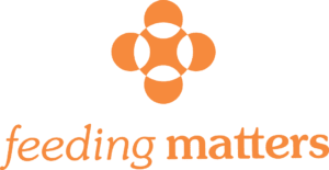 Feeding Matters logo. Orange flower-like icon above the words feeding matters in orange. Black background.